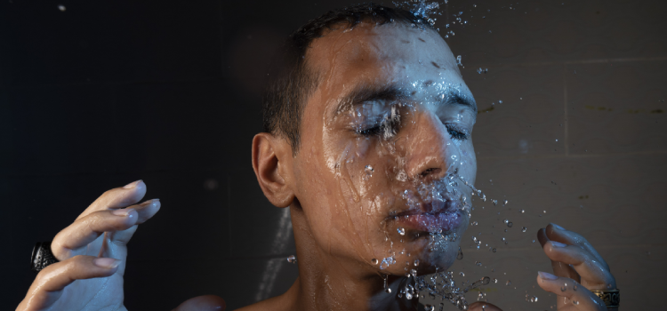 men washing his face