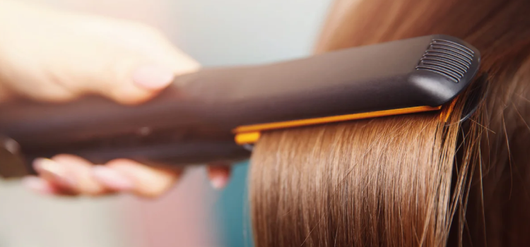 Straighting a womans hair with straightener